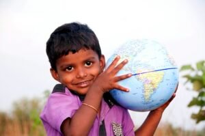 Indian boy holding a globe.